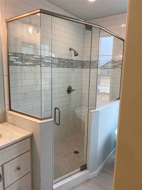 luxury metal framed glass shower enclosure|custom frameless shower doors installed.